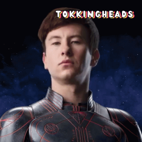 A Picture Of A Man In A Superhero Suit With The Words Tokingheads Above Him GIF