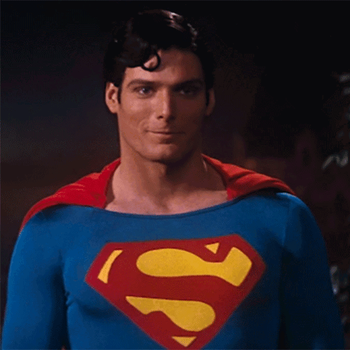 A Picture Of A Man In A Superman Costume With The Words " You Okay " Below Him GIF