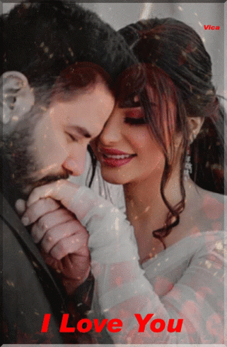 A Picture Of A Man Kissing A Woman 'S Hand With The Words " I Love You " On The Bottom GIF