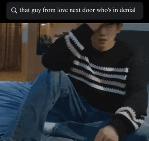 A Picture Of A Man Standing In Front Of A Bed With The Words That Guy From Love Next Door Who 'S In Denial At The Top GIF