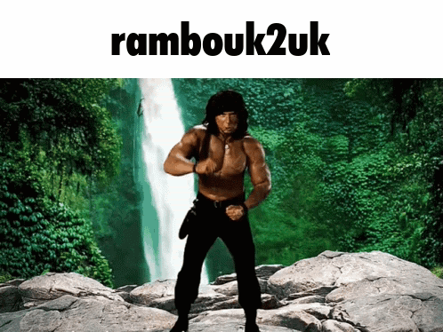 A Picture Of A Man Standing In Front Of A Waterfall With The Words " Rambouk2uk " Above Him GIF