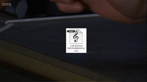 A Picture Of A Man With Long Hair And A Beard Is Behind A Bbc Logo GIF