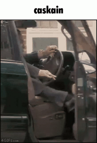 A Picture Of A Person Driving A Car With The Word Caskain Above Them GIF