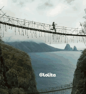 A Picture Of A Person Walking Across A Rope Bridge With The Words @Lolita At The Bottom GIF