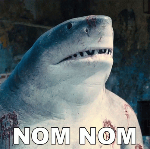 A Picture Of A Shark With The Words Nom Nom Written Below It GIF