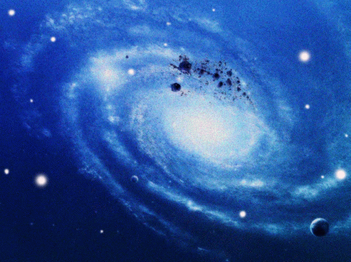 A Picture Of A Spiral Galaxy With A Planet In The Foreground GIF