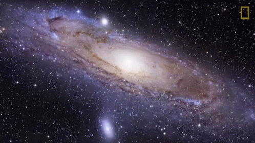 A Picture Of A Spiral Galaxy With The National Geographic Logo In The Corner GIF