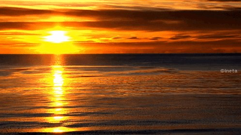 A Picture Of A Sunset Over A Body Of Water With The Watermark Ineta GIF