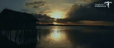 A Picture Of A Sunset Over A Body Of Water With The Words Wonderful Indonesia On The Bottom GIF