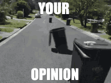 A Picture Of A Trash Can On The Side Of A Road With The Words Your Opinion GIF