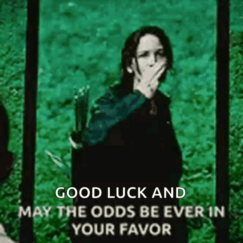 A Picture Of A Woman Covering Her Mouth With Her Hand With The Words Good Luck And May The Odds Be Ever In Your Favor . GIF