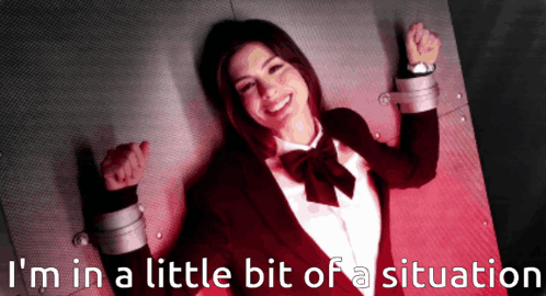 A Picture Of A Woman In A Suit And Bow Tie With The Words I 'M In A Little Bit Of A Situation Behind Her GIF