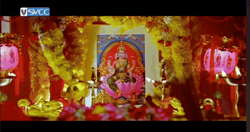 A Picture Of A Woman On A Lotus Flower Is Surrounded By Flowers And A Sign That Says Svcc On It GIF