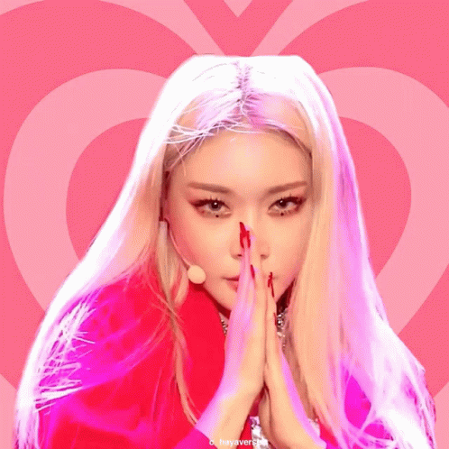 A Picture Of A Woman With A Pink Heart Behind Her GIF