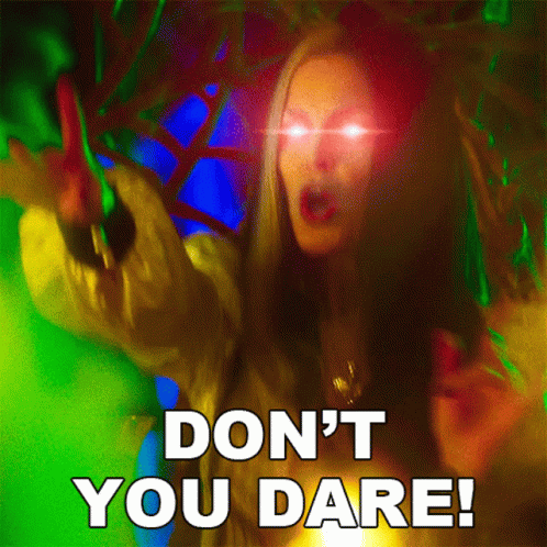 A Picture Of A Woman With Glowing Eyes And The Words " Don 'T You Dare " GIF