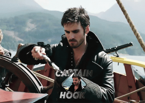 A Picture Of Captain Hook Holding A Sword On A Boat GIF
