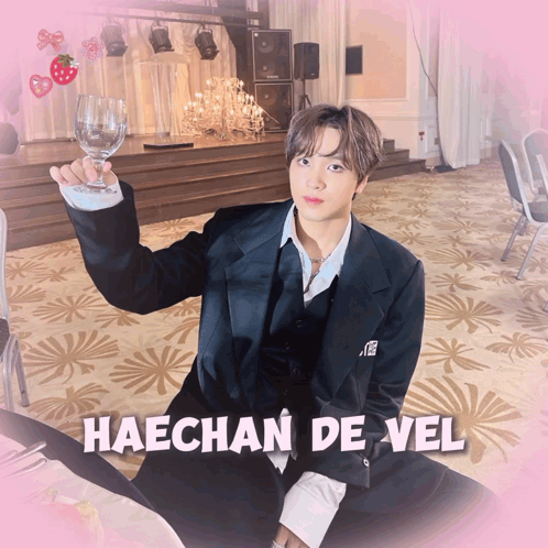 A Picture Of Haechan De Vel With A Glass Of Wine In His Hand GIF