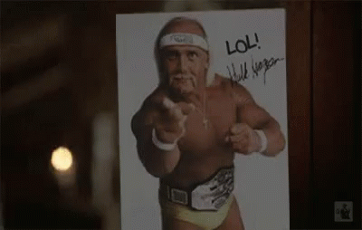 A Picture Of Hulk Hogan Pointing At The Camera With A Signature On It . GIF