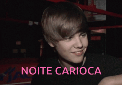 A Picture Of Justin Bieber With The Words Noite Carioca In Pink GIF
