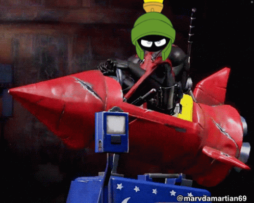 A Picture Of Marvin The Martian Riding A Rocket GIF