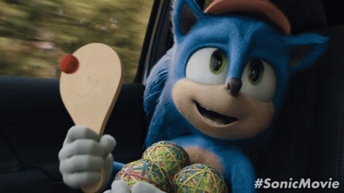 A Picture Of Sonic The Hedgehog Holding A Paddle And Balls GIF