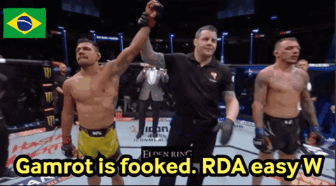 A Picture Of Two Men In A Ring With The Words Gamrot Is Fooked Rda Easy W GIF