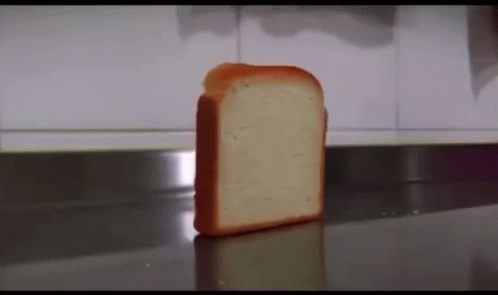 A Piece Of Bread Is Sitting On A Counter . GIF