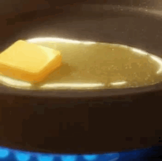 A Piece Of Butter Is Being Melted In A Pan Of Oil . GIF