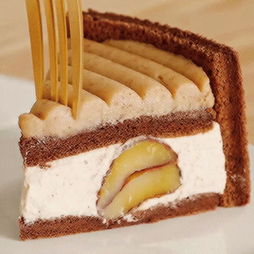A Piece Of Cake With A Fork Sticking Out Of It On A White Plate GIF