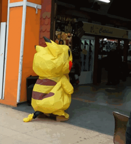 a pikachu costume is standing in front of a store that says catalina