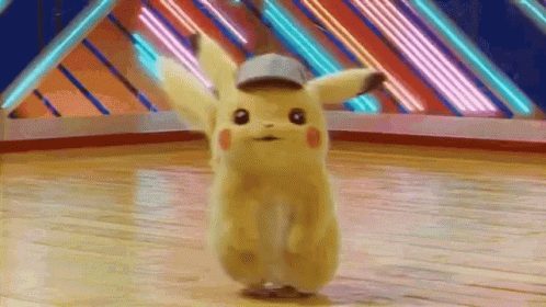 A Pikachu Is Dancing On A Wooden Floor In A Room . GIF
