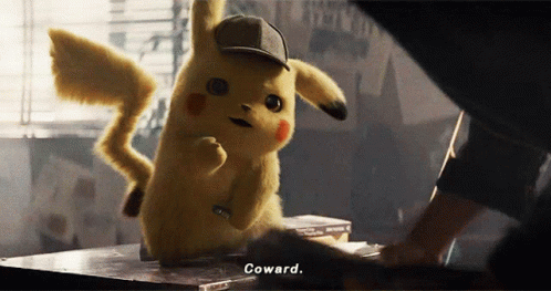 A Pikachu Wearing A Hat Says Coward While Standing On A Table GIF