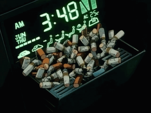A Pile Of Cigarettes Sits In Front Of A Digital Clock That Says 3:48 GIF