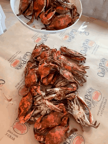 A Pile Of Crabs Sits On A Table Next To A Bowl Of Crabs From The Club Place GIF