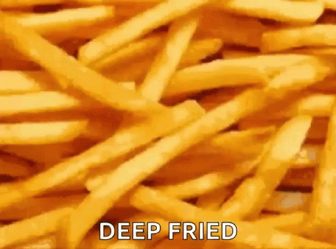 A Pile Of Deep Fried French Fries With The Words `` Deep Fried '' Written On It . GIF