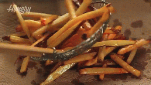 A Pile Of French Fries Are Being Scooped Out Of A Bowl With A Hungry Logo In The Background GIF