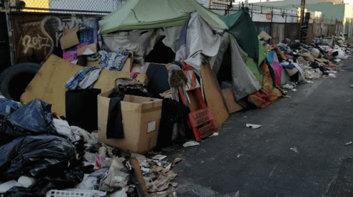 A Pile Of Garbage Including A Sign That Says Laundry Room GIF