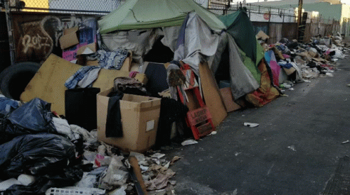 A Pile Of Garbage Including A Sign That Says Laundry Shop GIF