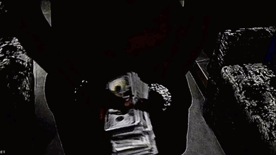 A Pile Of Money Is Sitting On Top Of A Table . GIF