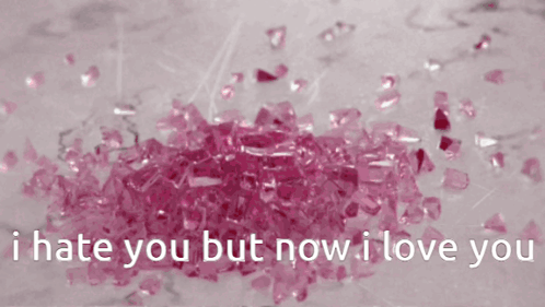 A Pile Of Pink Crystals With The Words " I Hate You But Now I Love You " Below Them GIF