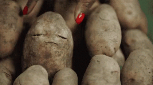A Pile Of Potatoes With A Face Drawn On One Of Them GIF