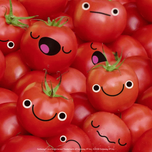 A Pile Of Tomatoes With Smiley Faces On Them GIF