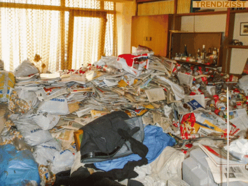 A Pile Of Trash In A Room With A Sign That Says Trendizisst On It GIF