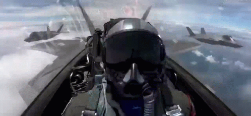 A Pilot Is Flying A Fighter Jet In The Sky With Other Fighter Jets . GIF