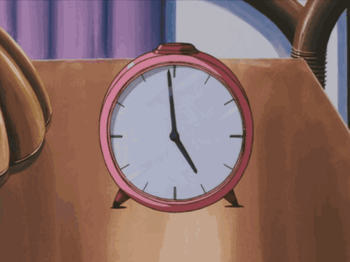 A Pink Alarm Clock On A Table Shows The Time As 5:00 GIF