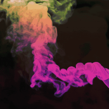 A Pink And Green Smoke Coming Out Of A Black Background GIF