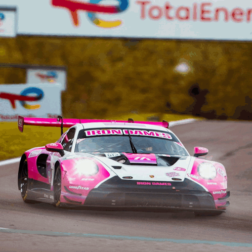 A Pink And White Race Car With The Word Iron On The Front GIF