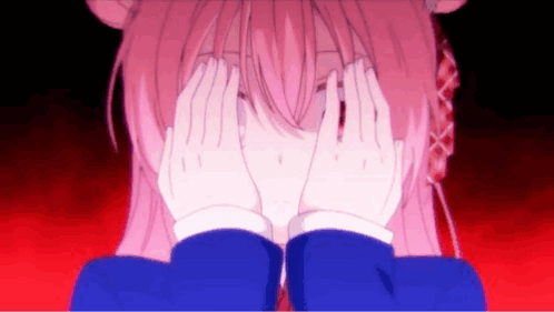 A Pink Anime Girl Is Covering Her Face With Her Hands . GIF