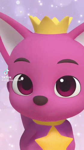 A Pink Baby Shark With A Yellow Crown On His Head GIF
