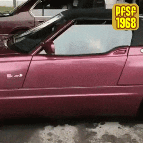 A Pink Car Is Parked Next To Another Car With A Sticker That Says Pasf 1968 GIF